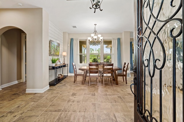 4419 Lea Ln, Fulshear, TX 77406 - dining area with a chandelier, arched walkways, and stone finish floors