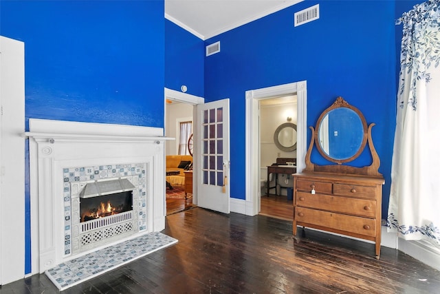 250 N Main St, Jasper, TX 75951 - living area featuring hardwood / wood-style floors, a high ceiling, ornamental molding, a tile fireplace, and french doors