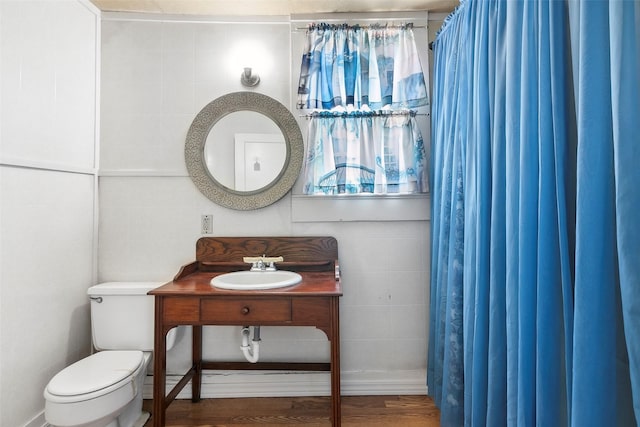 250 N Main St, Jasper, TX 75951 - bathroom with tile walls, vanity, and wood finished floors