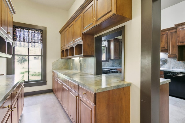 250 N Main St, Jasper, TX 75951 - kitchen with black dishwasher, open shelves, tasteful backsplash, and brown cabinets