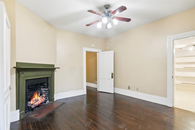 250 N Main St, Jasper, TX 75951 - unfurnished living room featuring hardwood / wood-style flooring, ceiling fan, and a warm lit fireplace