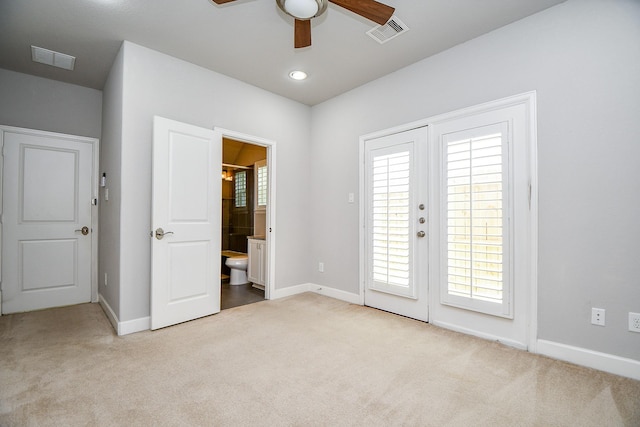 1909 Hickory St, Houston, TX 77007 - unfurnished bedroom featuring carpet flooring, access to outside, connected bathroom, and ceiling fan