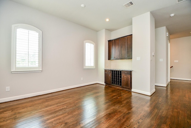 1909 Hickory St, Houston, TX 77007 - unfurnished living room with dark wood finished floors, a bar, and recessed lighting