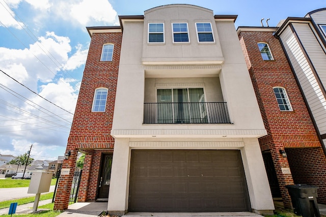 1909 Hickory St, Houston, TX 77007 - view of property with stucco siding, an attached garage, and brick siding
