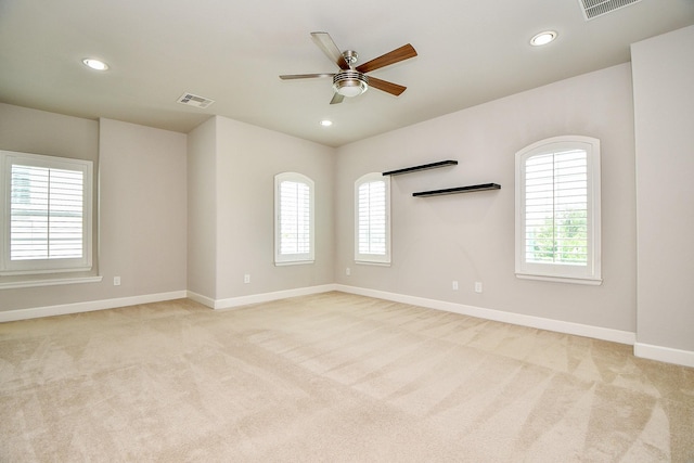 1909 Hickory St, Houston, TX 77007 - empty room with light carpet, healthy amount of natural light, a ceiling fan, and recessed lighting