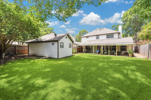 607 Ellingham Dr, Katy, TX 77450 - rear view of house with a chimney, a fenced backyard, an outbuilding, and a patio