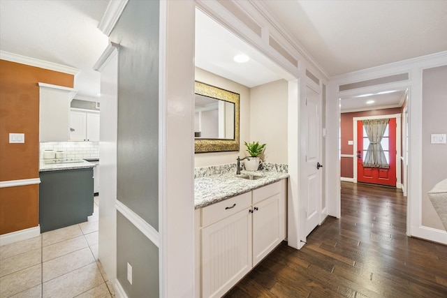 607 Ellingham Dr, Katy, TX 77450 - bathroom featuring backsplash, vanity, crown molding, and wood finished floors