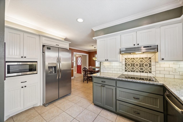 607 Ellingham Dr, Katy, TX 77450 - kitchen featuring appliances with stainless steel finishes, under cabinet range hood, gray cabinetry, crown molding, and tasteful backsplash