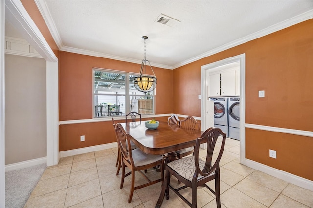 607 Ellingham Dr, Katy, TX 77450 - dining room with separate washer and dryer, crown molding, and light tile patterned floors