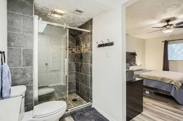 1902 Pepperrell Place Ct, Katy, TX 77493 - ensuite bathroom featuring a textured ceiling, a stall shower, wood finished floors, and ceiling fan