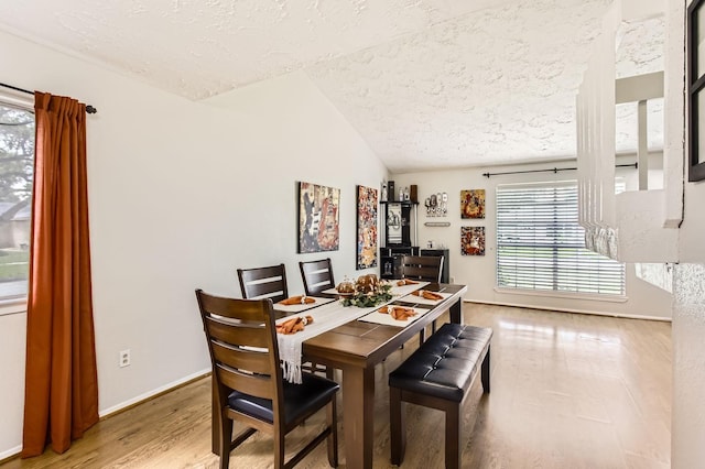 1902 Pepperrell Place Ct, Katy, TX 77493 - dining space featuring a textured ceiling, lofted ceiling, and wood finished floors