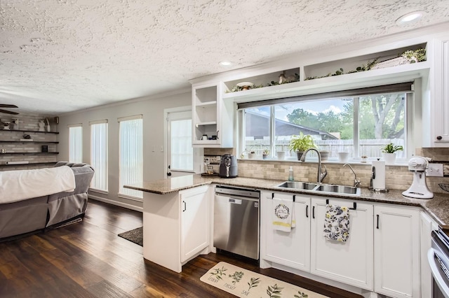 1902 Pepperrell Place Ct, Katy, TX 77493 - kitchen featuring dishwasher, a textured ceiling, a peninsula, open floor plan, and decorative backsplash