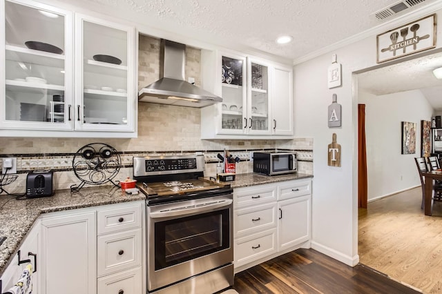 1902 Pepperrell Place Ct, Katy, TX 77493 - kitchen with wall chimney range hood, electric stove, dark wood-style flooring, white cabinetry, and stone countertops