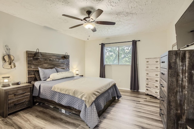 1902 Pepperrell Place Ct, Katy, TX 77493 - bedroom featuring light wood-type flooring, a textured ceiling, and ceiling fan
