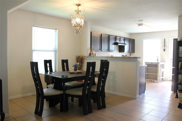 9914 Waldens Pond Ct, Houston, TX 77044 - dining room with light tile patterned floors and a chandelier