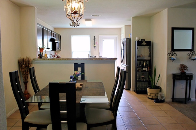 9914 Waldens Pond Ct, Houston, TX 77044 - dining space with light tile patterned floors and a chandelier