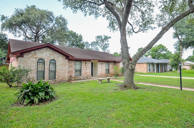 22127 Kerryblue Dr, Katy, TX 77450 - single story home featuring a front yard, a shingled roof, and brick siding