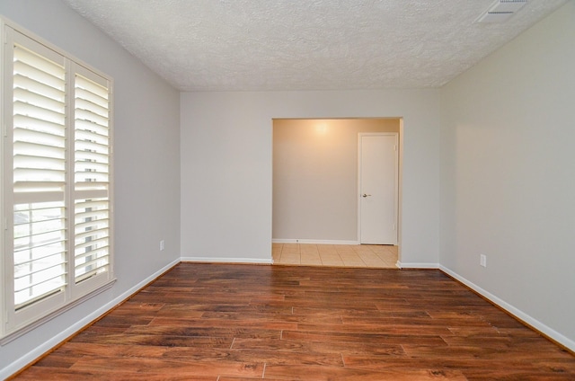 22127 Kerryblue Dr, Katy, TX 77450 - unfurnished room with plenty of natural light, a textured ceiling, and wood finished floors