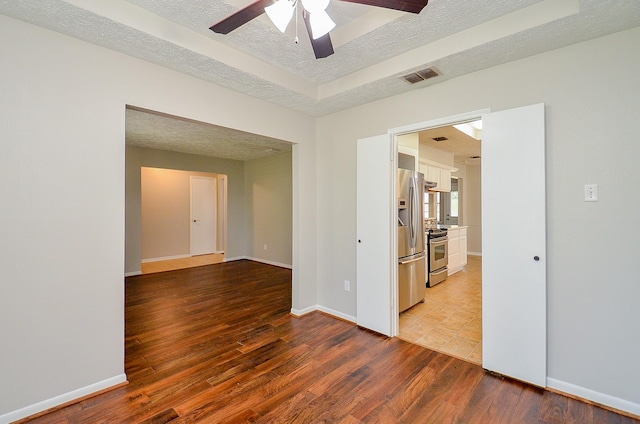 22127 Kerryblue Dr, Katy, TX 77450 - spare room featuring a textured ceiling, a ceiling fan, and light wood-style floors