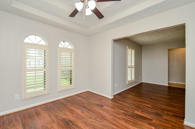 22127 Kerryblue Dr, Katy, TX 77450 - spare room with wood finished floors, a ceiling fan, a textured ceiling, and a tray ceiling