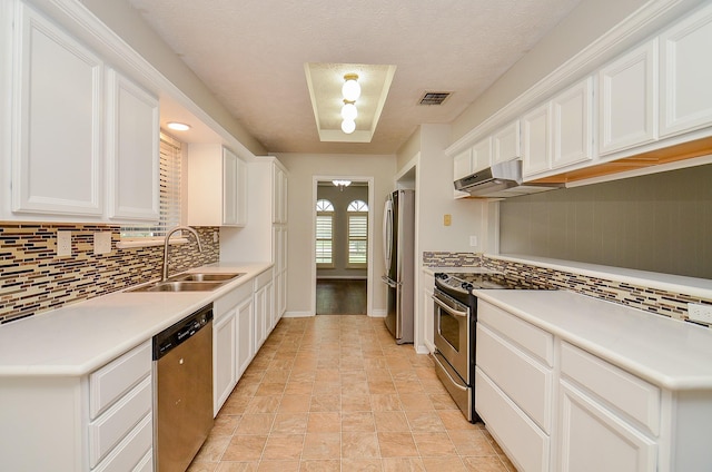 22127 Kerryblue Dr, Katy, TX 77450 - kitchen featuring stainless steel appliances, ventilation hood, backsplash, and white cabinetry