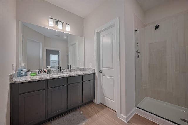 3213 Overfalls Dr, Santa Fe, TX 77510 - bathroom with a tile shower, wood finished floors, and vanity