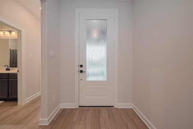 3213 Overfalls Dr, Santa Fe, TX 77510 - doorway featuring light wood-style floors and baseboards
