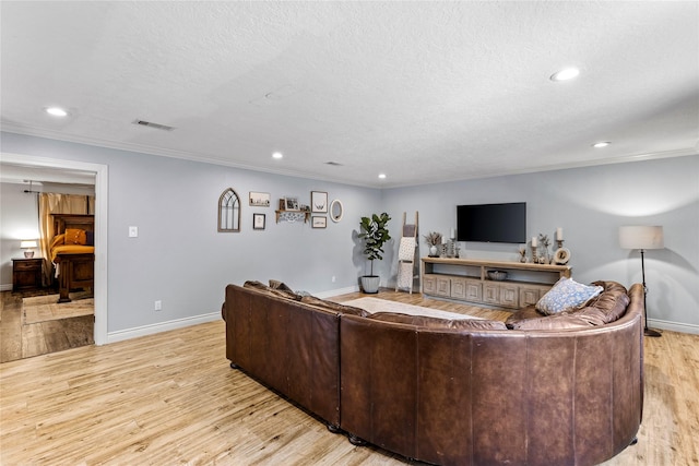 112 April Wind Dr E, Montgomery, TX 77356 - living room featuring recessed lighting, light wood finished floors, crown molding, and a textured ceiling