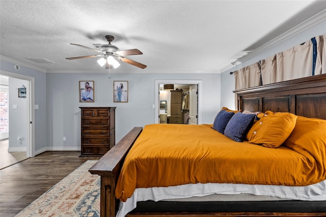 112 April Wind Dr E, Montgomery, TX 77356 - bedroom with wood finished floors, ornamental molding, a ceiling fan, a walk in closet, and a textured ceiling