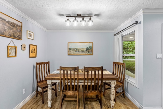 112 April Wind Dr E, Montgomery, TX 77356 - dining area featuring light wood finished floors, ornamental molding, and a textured ceiling