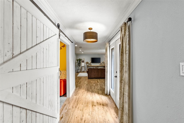 112 April Wind Dr E, Montgomery, TX 77356 - corridor with a barn door and light wood finished floors