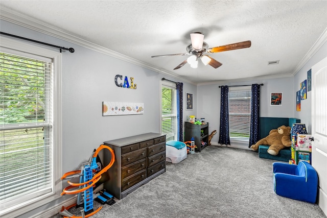 112 April Wind Dr E, Montgomery, TX 77356 - playroom with carpet, a ceiling fan, ornamental molding, and a textured ceiling