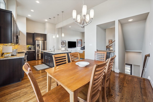 4102 Marina St, Houston, TX 77007 - dining room featuring a chandelier, wood finished floors, recessed lighting, a high ceiling, and stairway