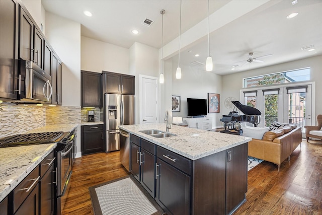 4102 Marina St, Houston, TX 77007 - kitchen with stainless steel appliances, open floor plan, a ceiling fan, dark wood finished floors, and decorative backsplash