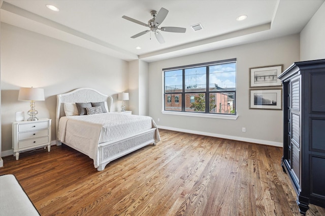 4102 Marina St, Houston, TX 77007 - bedroom featuring wood finished floors, recessed lighting, a ceiling fan, and a raised ceiling