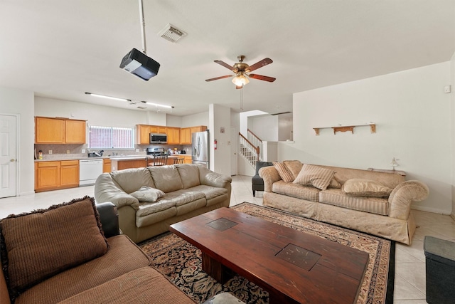 1327 Bartlett Cove Dr, Houston, TX 77067 - living area with ceiling fan, light tile patterned flooring, and stairs