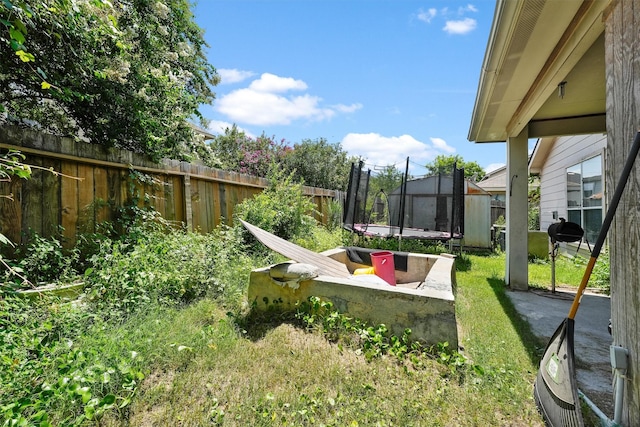 1327 Bartlett Cove Dr, Houston, TX 77067 - fenced backyard featuring a trampoline and a patio area