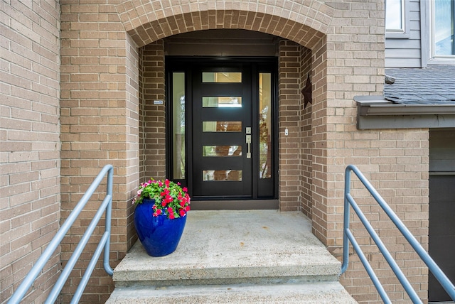 18405 Sandy Cv, Houston, TX 77058 - view of exterior entry with brick siding and roof with shingles