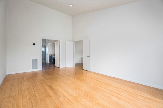 18405 Sandy Cv, Houston, TX 77058 - spare room with a towering ceiling and light wood-type flooring