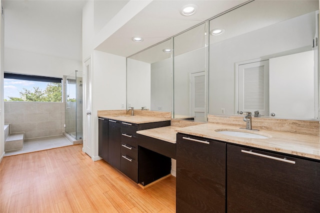 18405 Sandy Cv, Houston, TX 77058 - bathroom with a shower stall, vanity, wood finished floors, a garden tub, and recessed lighting