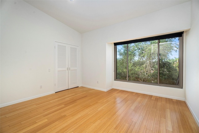 18405 Sandy Cv, Houston, TX 77058 - empty room featuring light wood-style flooring and lofted ceiling