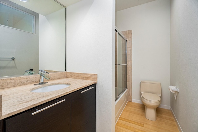 18405 Sandy Cv, Houston, TX 77058 - full bathroom with vanity, wood finished floors, and enclosed tub / shower combo