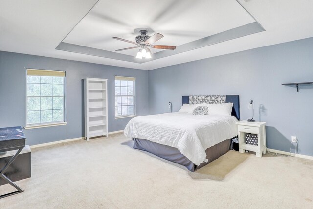 2726 Indigo Stone Ln, Katy, TX 77449 - carpeted bedroom featuring a tray ceiling and ceiling fan