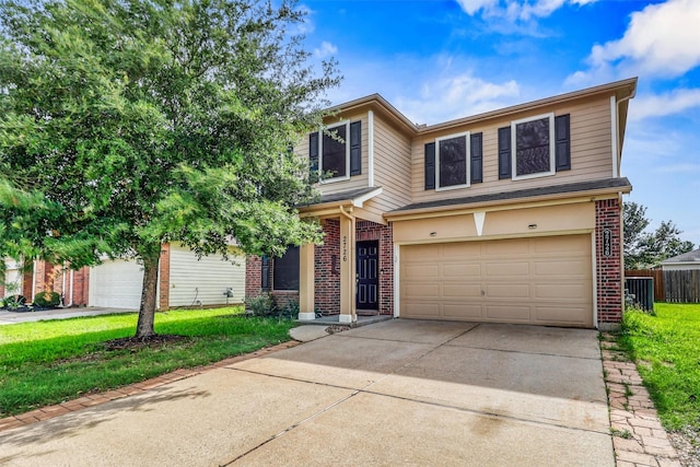 2726 Indigo Stone Ln, Katy, TX 77449 - traditional-style house with brick siding, driveway, and a garage