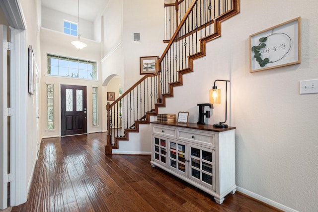 9215 Union Meadow Ln, Cypress, TX 77433 - foyer entrance featuring arched walkways, dark wood-type flooring, stairway, and a towering ceiling