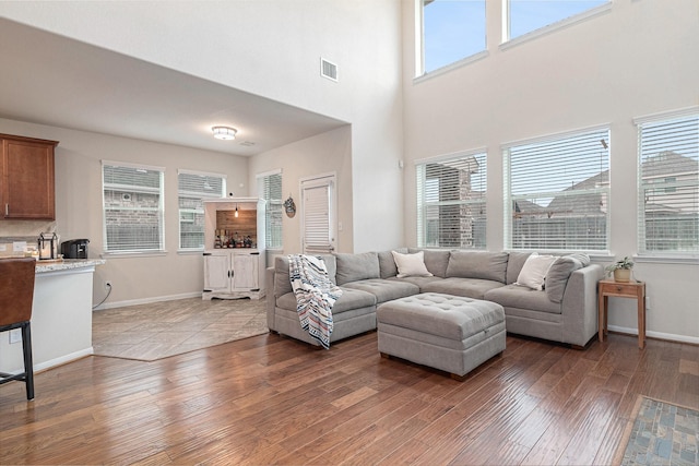 9215 Union Meadow Ln, Cypress, TX 77433 - living area with wood-type flooring, plenty of natural light, and a towering ceiling