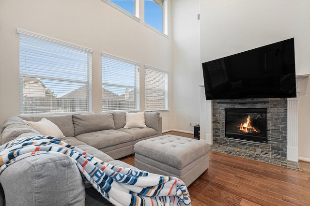 9215 Union Meadow Ln, Cypress, TX 77433 - living area with wood finished floors, a fireplace with flush hearth, and a towering ceiling