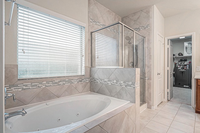 9215 Union Meadow Ln, Cypress, TX 77433 - bathroom with a stall shower, a jetted tub, a walk in closet, and tile patterned floors