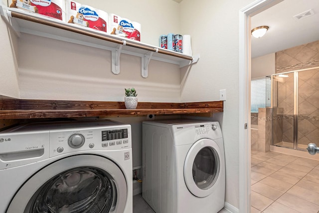 9215 Union Meadow Ln, Cypress, TX 77433 - laundry room with washer and clothes dryer and light tile patterned floors