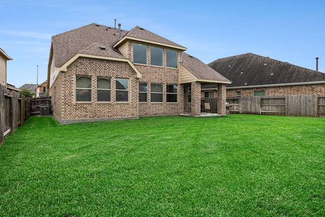 9215 Union Meadow Ln, Cypress, TX 77433 - rear view of house with brick siding, a fenced backyard, roof with shingles, and a patio